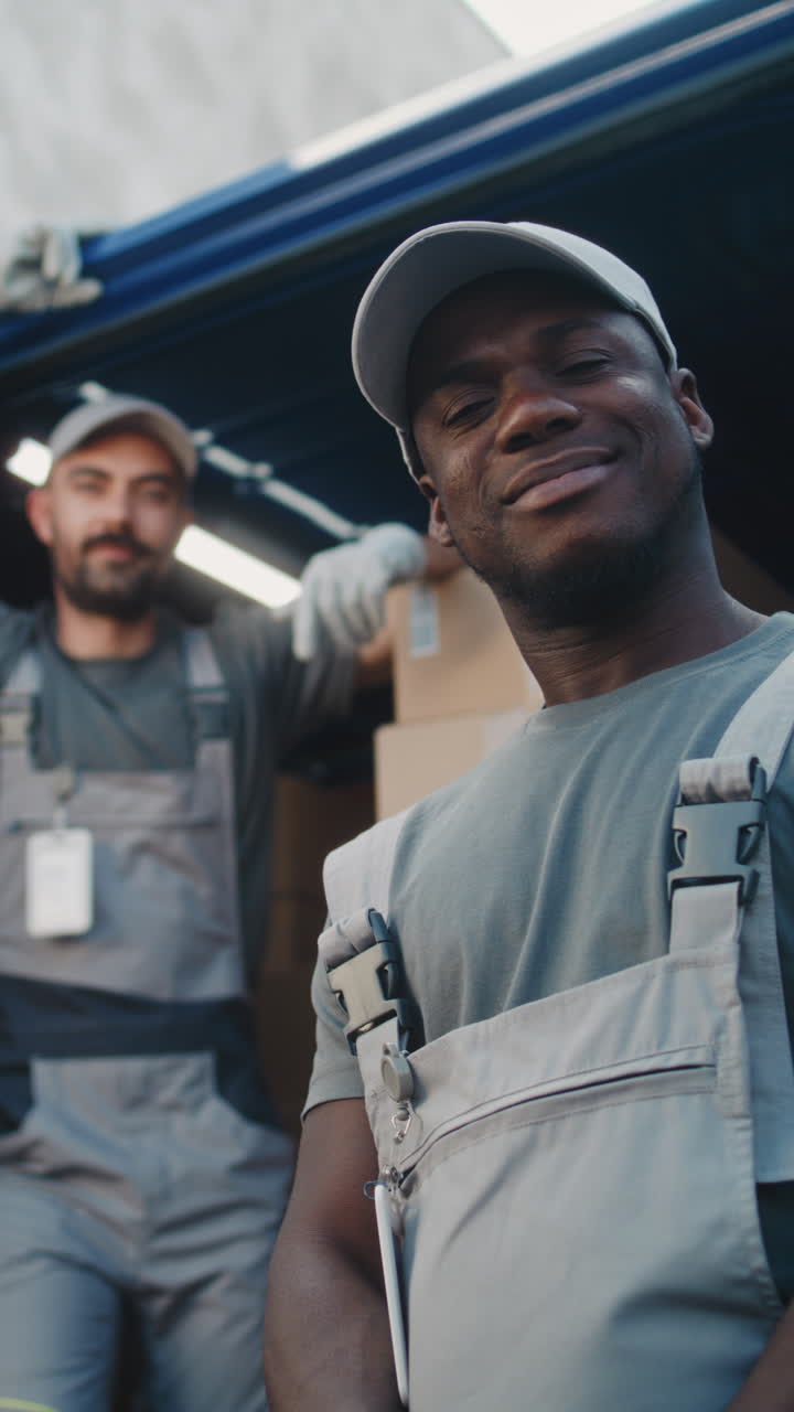 Smiling Delivery Workers with Boxes in a Van