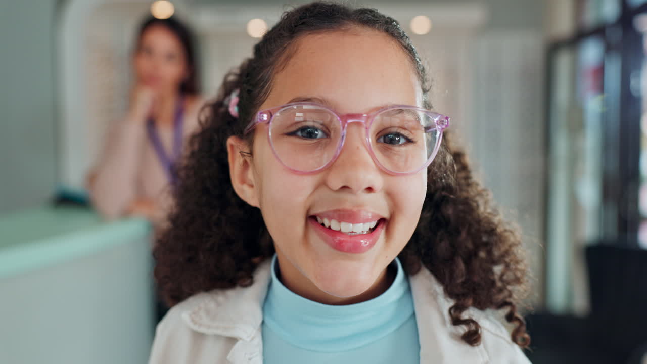 Girl with pink glasses at an eye exam