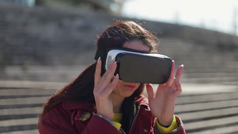 Beautiful-smiling-mature-woman-with-long-hair-taking-off-VR-glasses