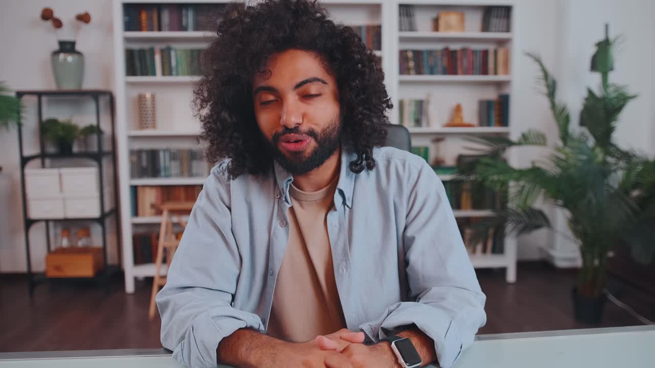 Camera view young arabian man talks and smiling during online interview