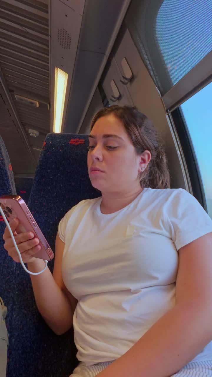 A Woman Candid Moment Browsing Her Phone on a Train