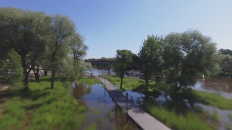 wooden walkway surrounded by flooded river water