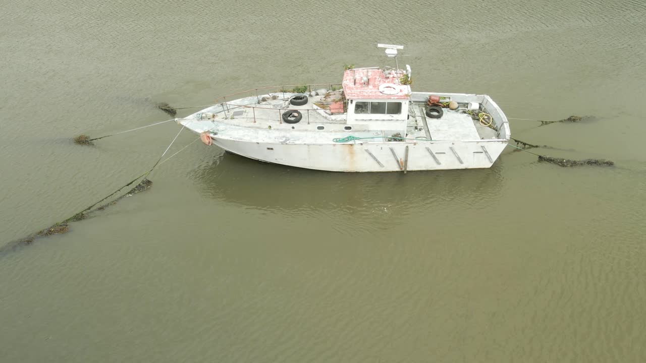 barco oxidado anclado en el río en youghal, condado de cork, irlanda, rodeado de aguas tranquilas