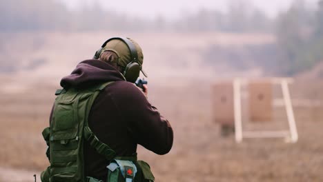 Ein-Jäger-Mit-Kopfhörern-Schießt-Mit-Einer-Waffe-3