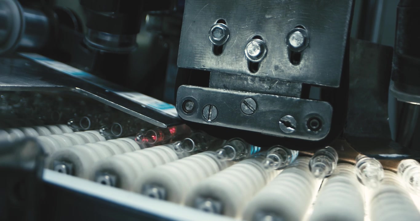 Close-up view of a machine precisely labeling glass jars using advanced technology, ensuring accuracy and efficiency in the labeling process.