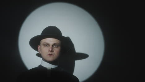 spotlight portrait of man in priest costume