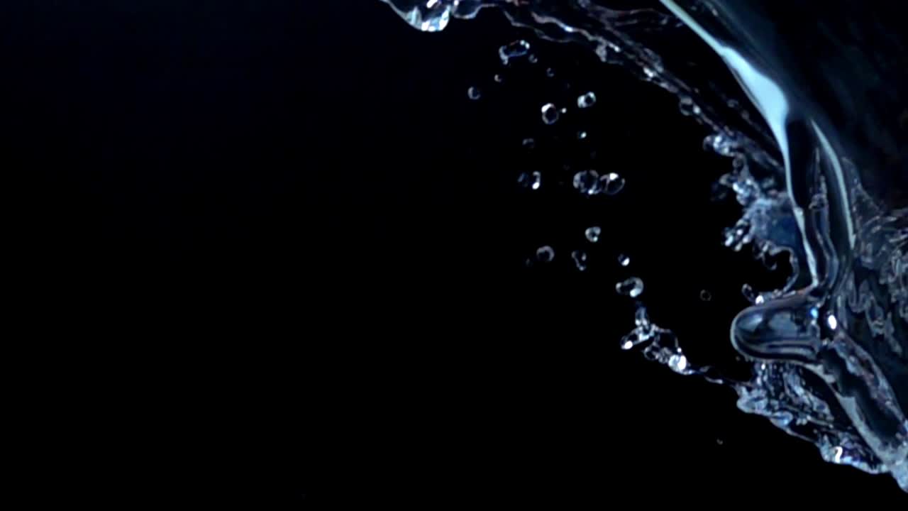 Water on a black background. Slow motion