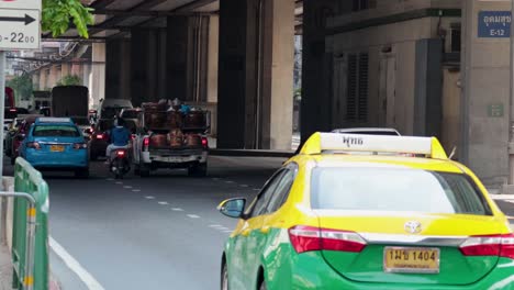 vehicles moving under an overpass in bangkok