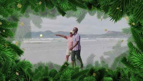 animation of christmas decorations over senior african american couple on beach