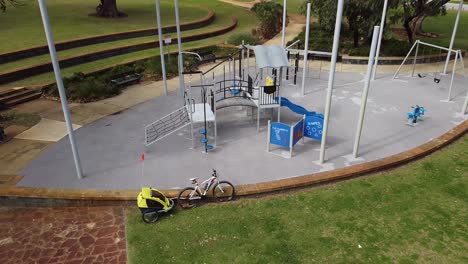 Aerial-Descend-Near-Empty-Children's-Playground-Park-Equipment