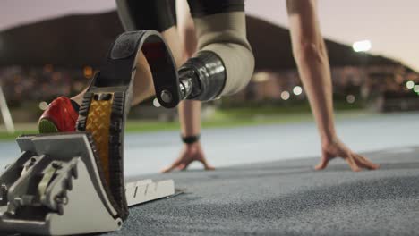 low section of caucasian disabled male athlete with running blade getting ready to start a run