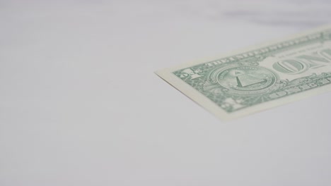 close up currency shot of hand grabbing us 1 dollar bill on marble background 1