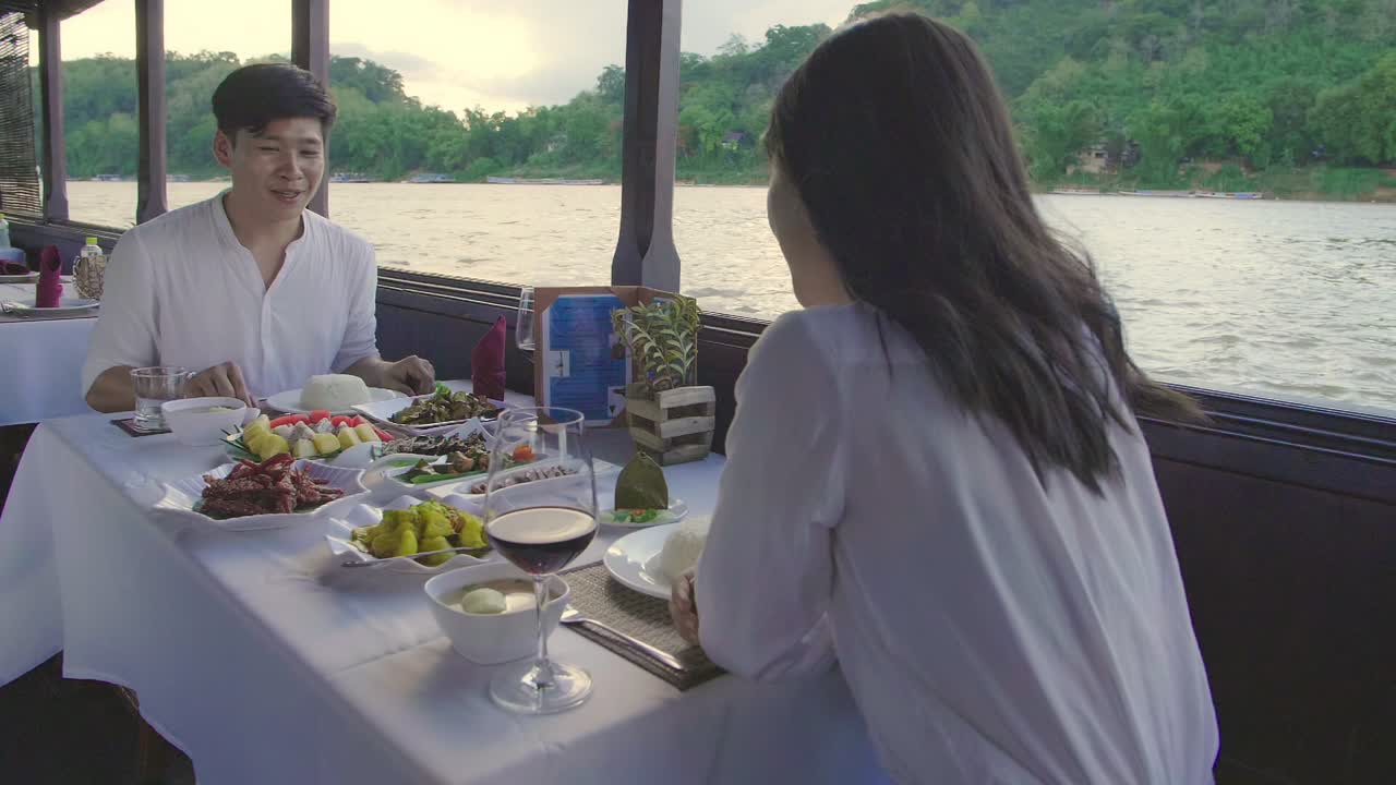 Couple enjoying a romantic dinner on a river cruise