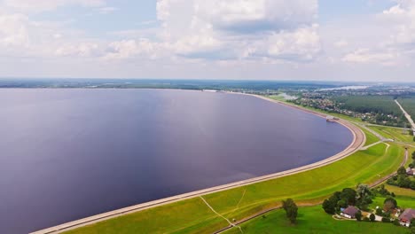 aerial captures wide arc of riga hes reservoir stretching toward the horizon