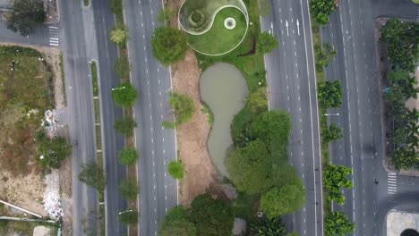 top down aerial perspective of large highway roads and zen peace symbol in grass median of vietnam