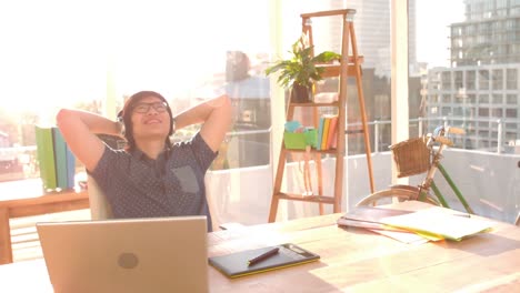 happy hipster resting at desk in office