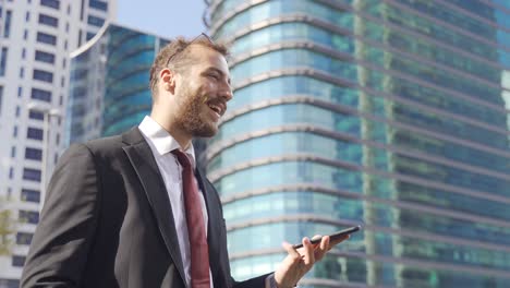 Businessman-standing-near-Company-Buildings.