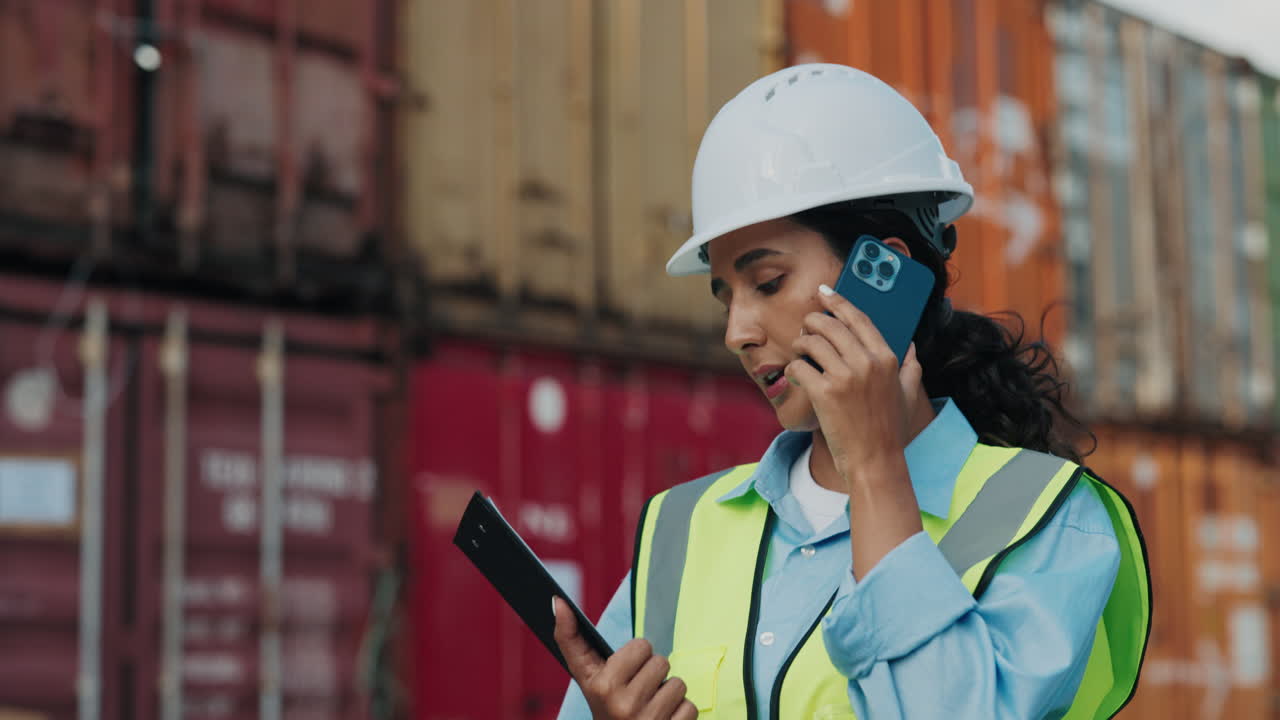 Woman worker in port talking on phone