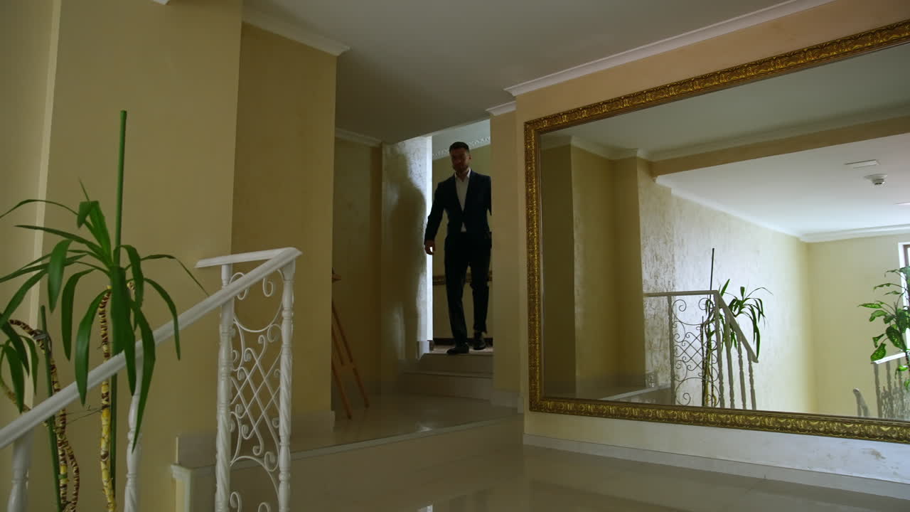 Businessman in hallway of hotel. Young businessman in formalwear moving along hotel