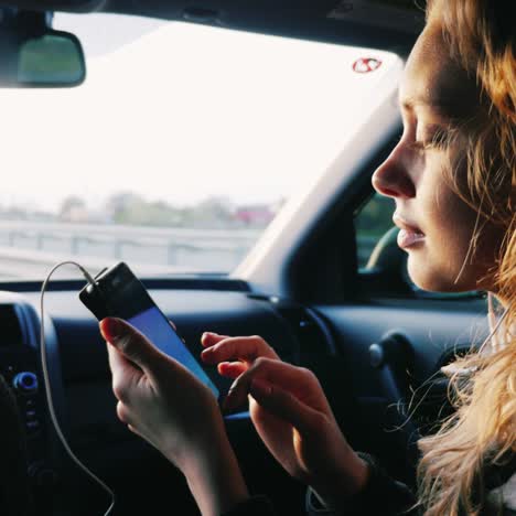 una mujer joven con un teléfono viaja en el asiento del pasajero delantero del camión