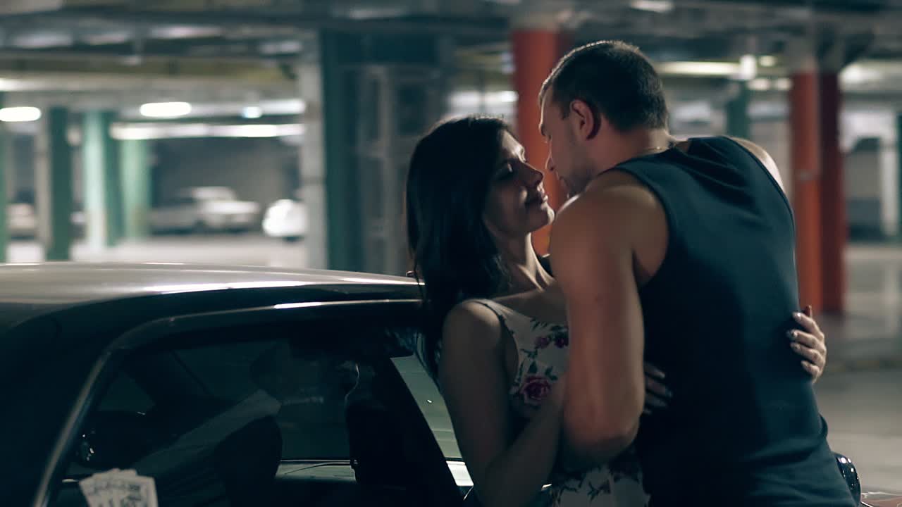 Close round motion man hugs and kisses woman near car | Premium Stock ...