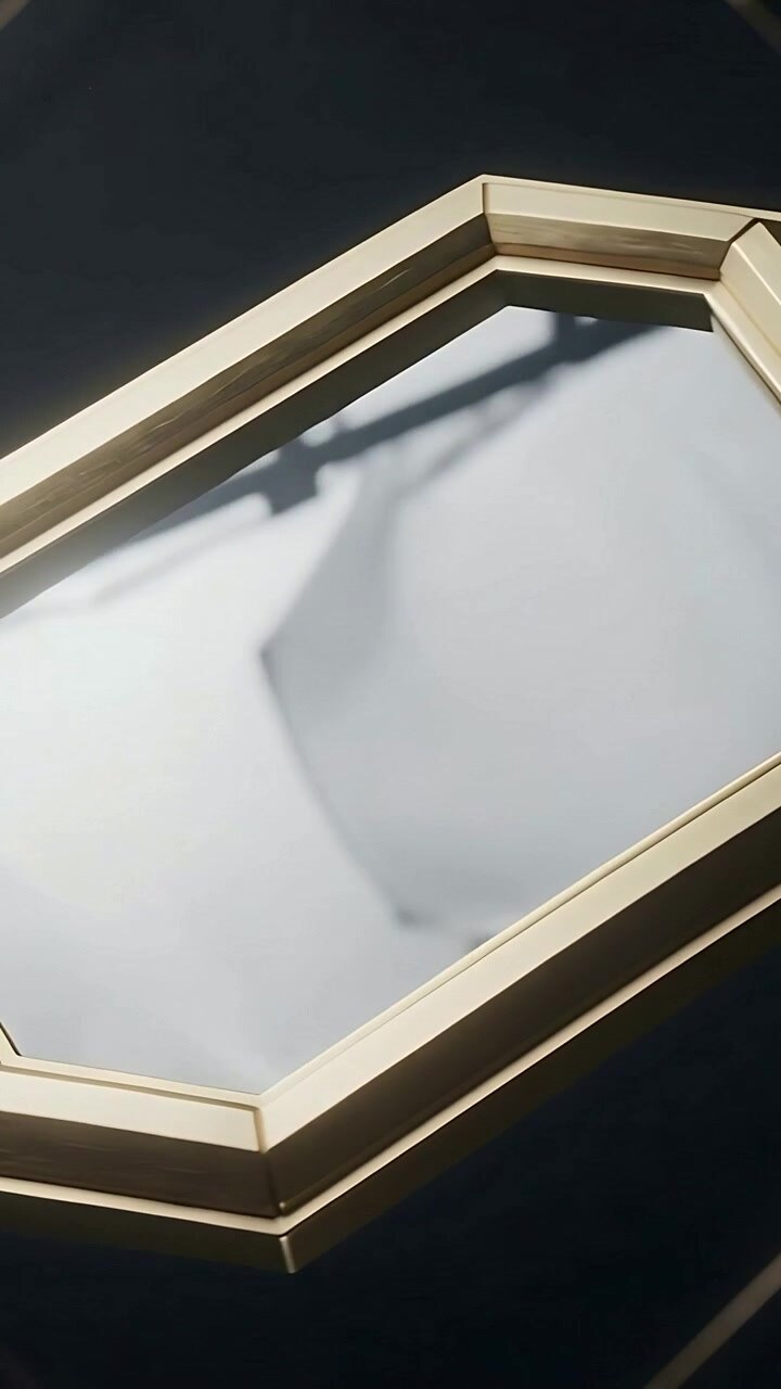 Vertical video: Moving camera centering brass octagon on glossy panel, exposing cloth reflection