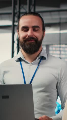 vertical video portrait of multiethnic employees work with performance metrics and high tech
