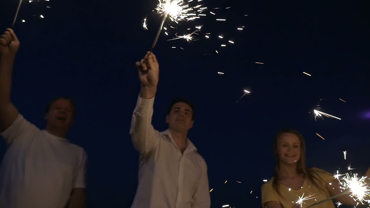 gente encendiendo fuegos bengalíes