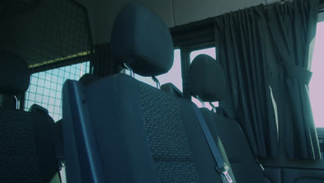 Beautiful-slow-motion-shot-of-the-seats-inside-a-very-large,-elegant-and-modern-black-van-for-transporting-musical-bands-in-Madrid