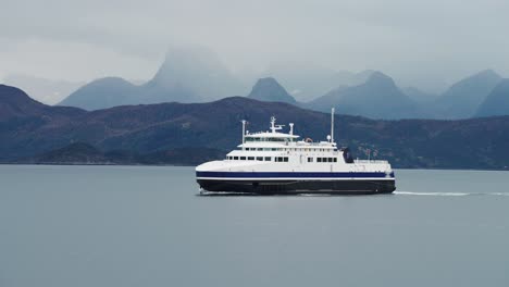 a huge passenger ferry crosses norwegian fjod