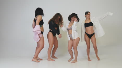 four diverse women dancing