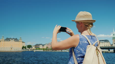 the tourist photographs a famous arch near the parliament in stockholm tourism in scandinavia concep