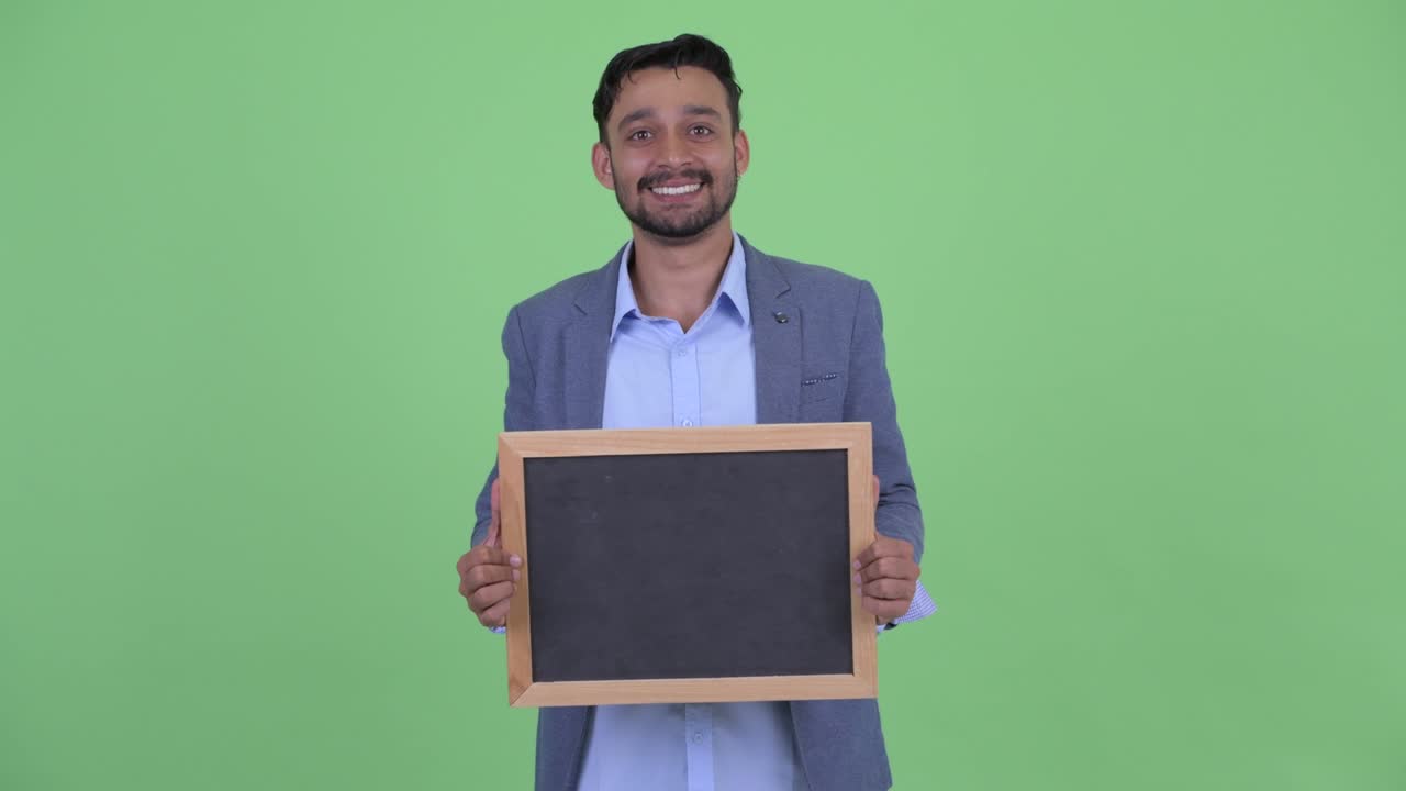 Young handsome bearded Persian businessman in suit