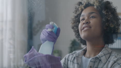 young woman cleaning window