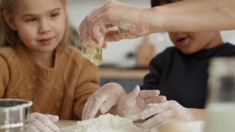 video of children looking at egg cracked by mom