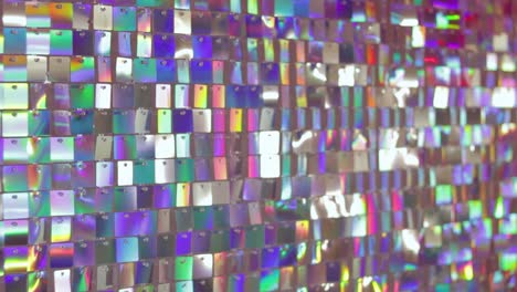 iridescent sequin panel with shifting colors, creating a vibrant and reflective surface