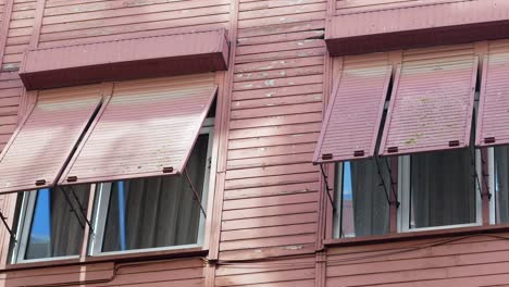 pink building with vintage shutters