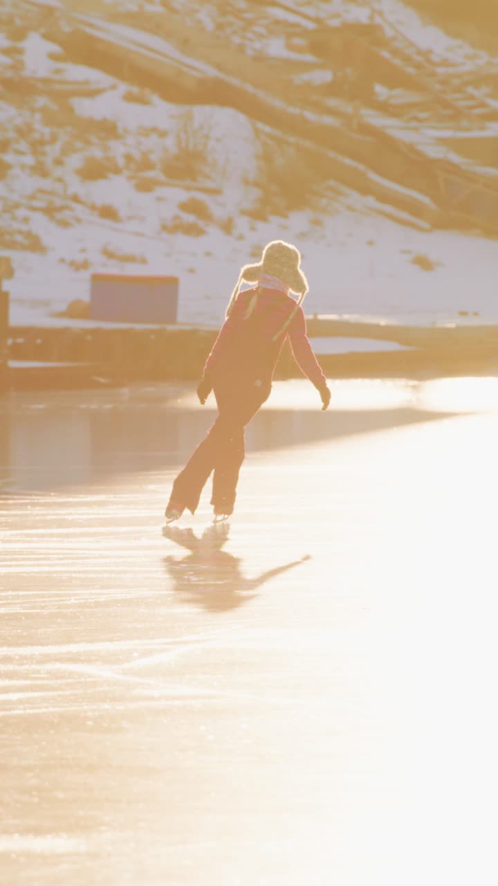 A Graceful Skater Glides Across the Ice in Majestic Winter Light, Capturing the Essence of Joy and Freedom in a Beautiful Frozen Landscape Enhanced by a Glimmering Sunset Glow