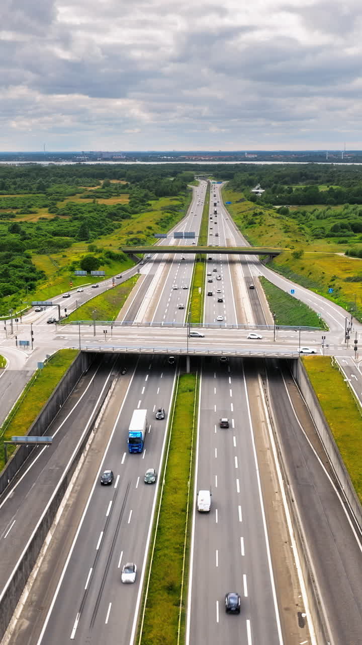 Aerial drone view of the European route E20 on a cloudy day. Vertical