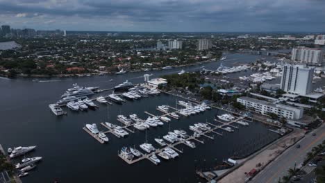 aerial drone shot of a port city with dozens of boats lined up around its waters