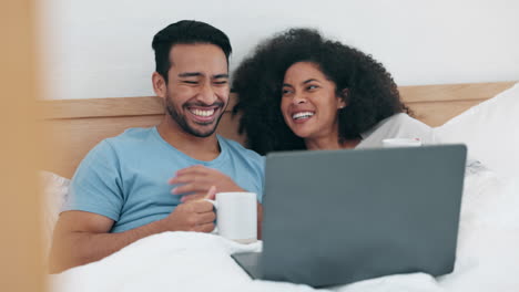 Laptop,-video-and-funny-with-a-couple-in-bed