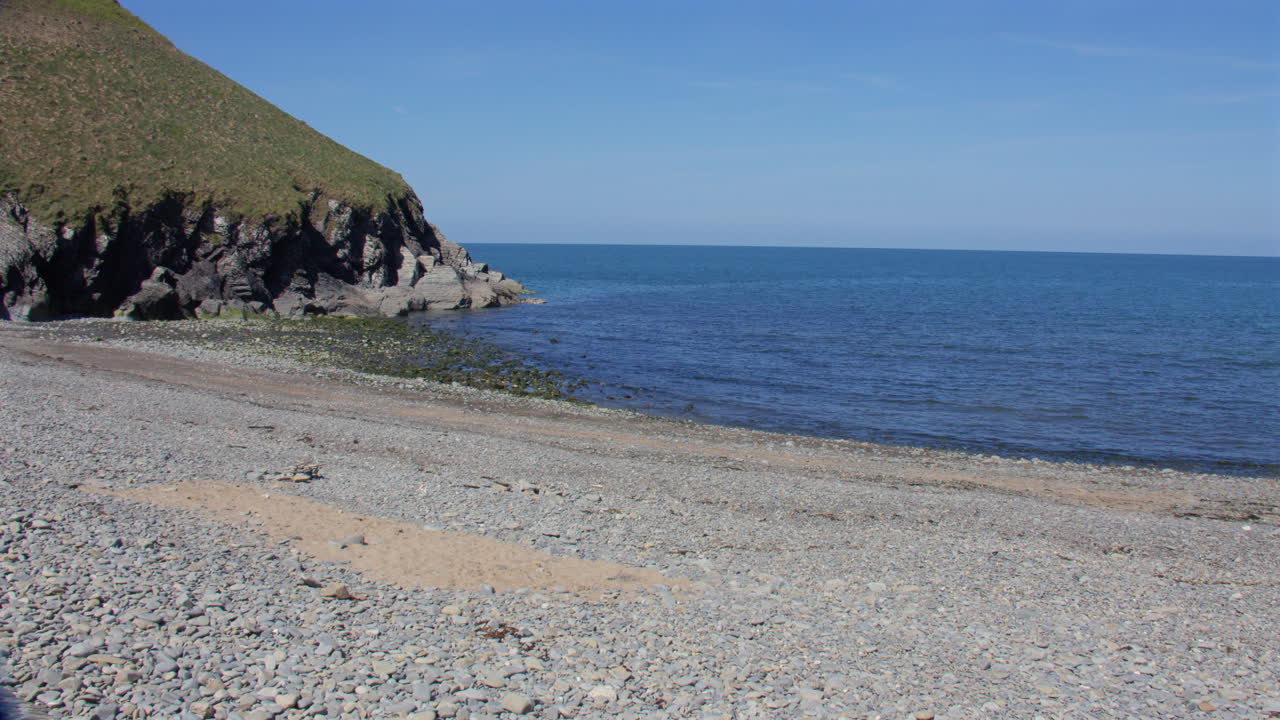 Wide shot looking West at Cwmtydu Beach at low tide