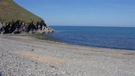Wide shot looking West at Cwmtydu Beach at low tide