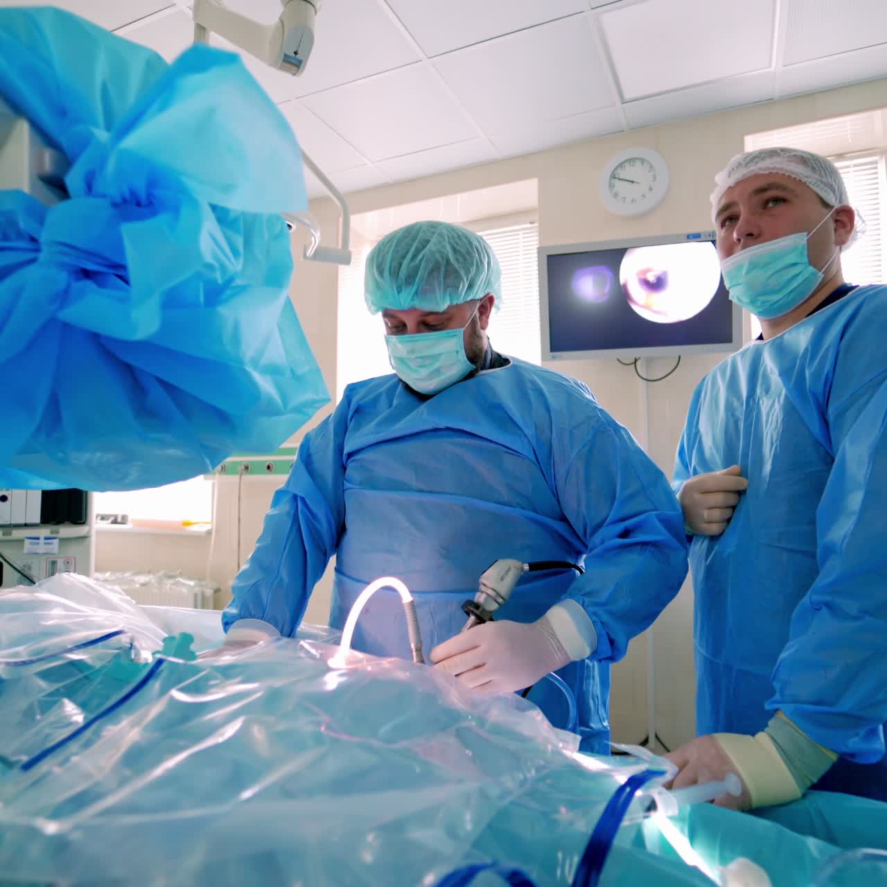 Doctors performing surgery in hospital