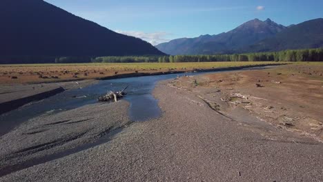 Aerial-flight-over-shallow-streams-that-don't-carry-enough-water-to-form-a-lake-as-not-enough-snow-grew-on-local-mountains-that-feed-Ross-lake