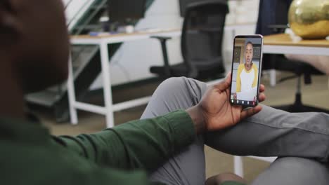 African-american-businessman-using-smartphone-for-video-call-with-business-colleague