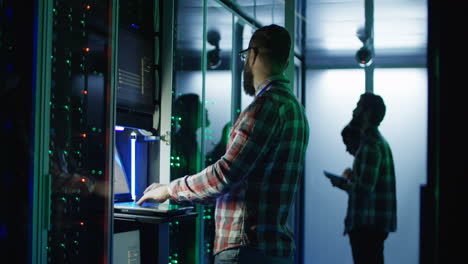 it technician working in server room at night