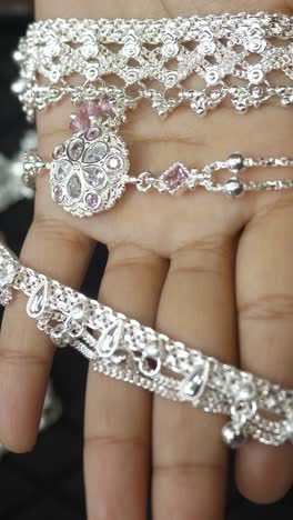 indian style silver anklets, silver jewellery, closeup, vertical shot