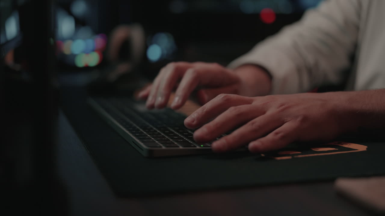 Person Typing on a Keyboard at a Computer Workstation