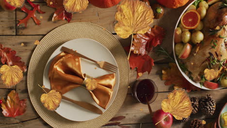 animation of autumn leaves falling over thanksgiving dinner background